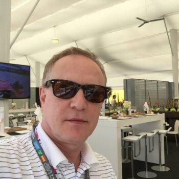 A man in a marquee wearing sunglasses