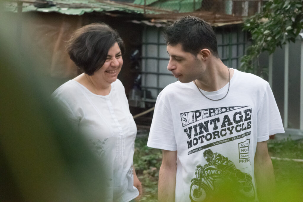 A man and a woman walking on a garden