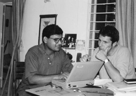 Akhil and Richard sit at a table talking