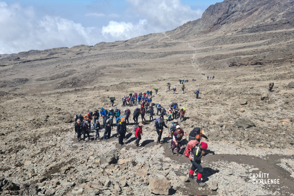 Hikers walking along a rocky terrain.