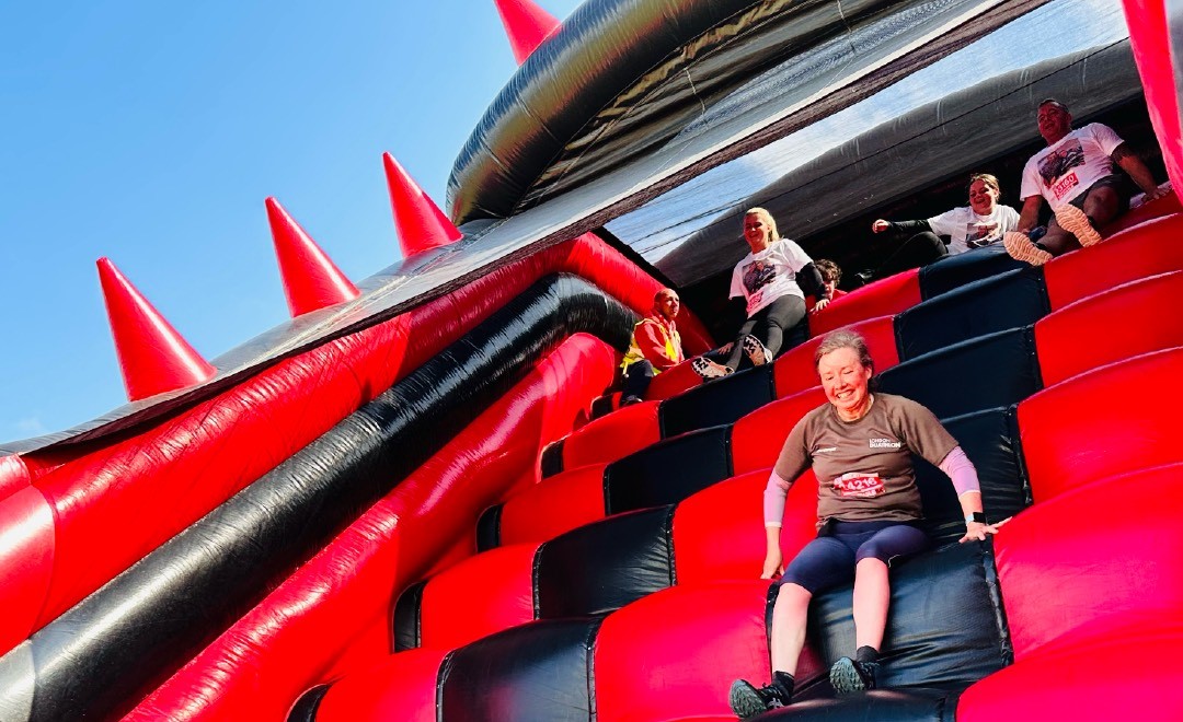 People sliding down an inflatabel slide.