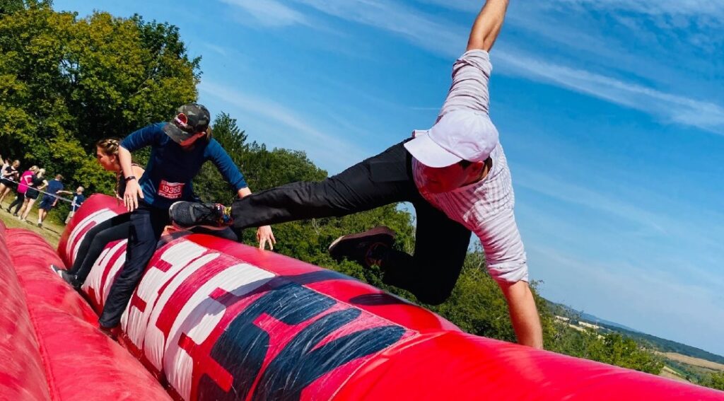 A person jumping over an inflatabel obstacle