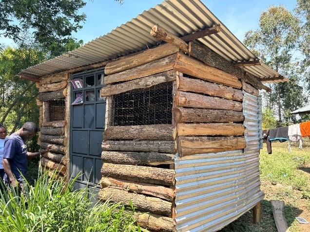 A chicken coup made out of logs